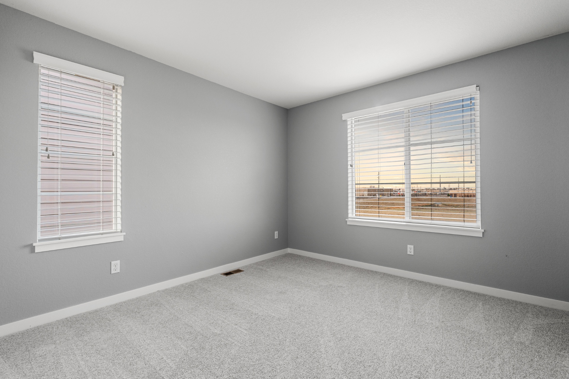 Secondary bedroom with carpet and natural light