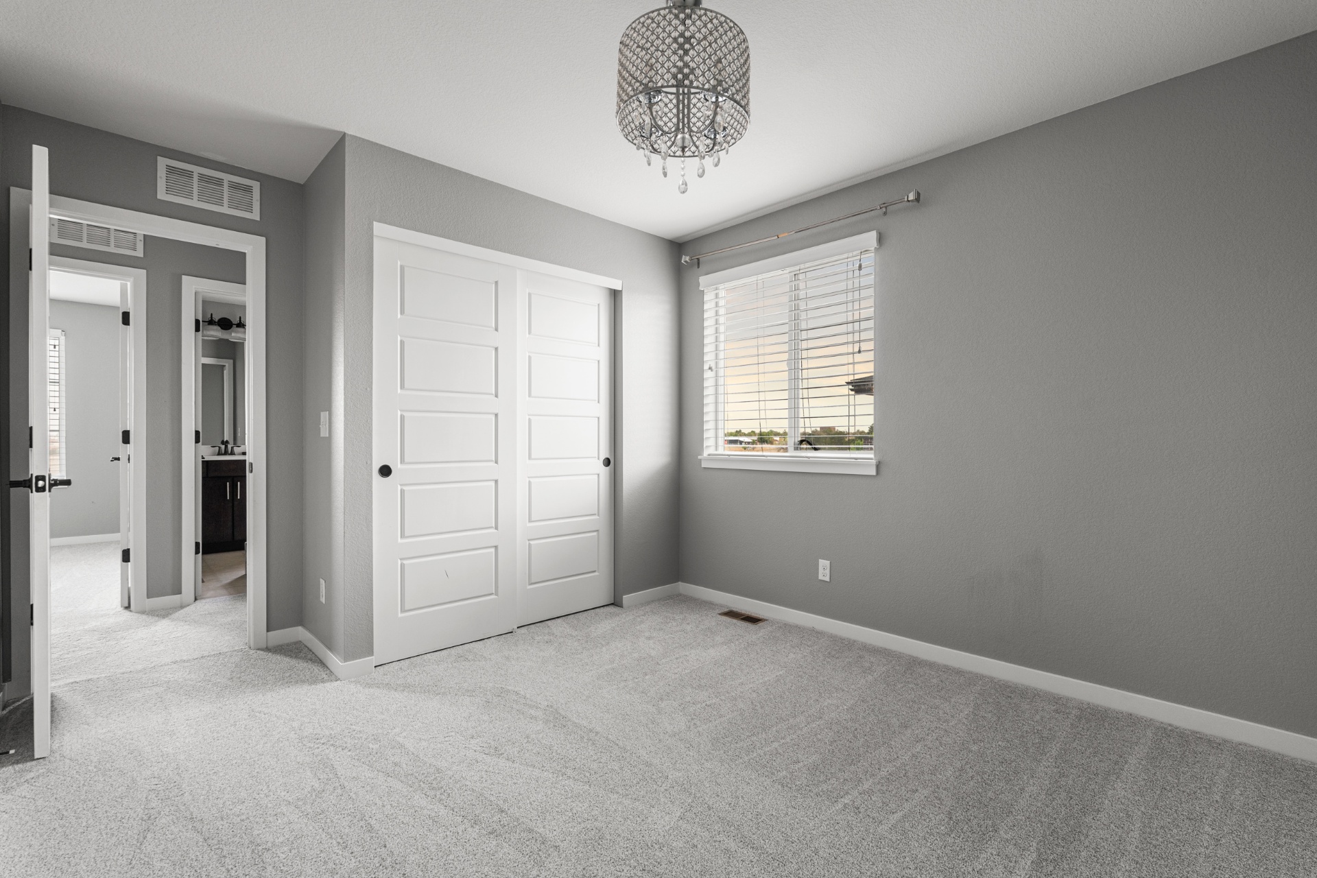 Third bedroom with closet and chandelier