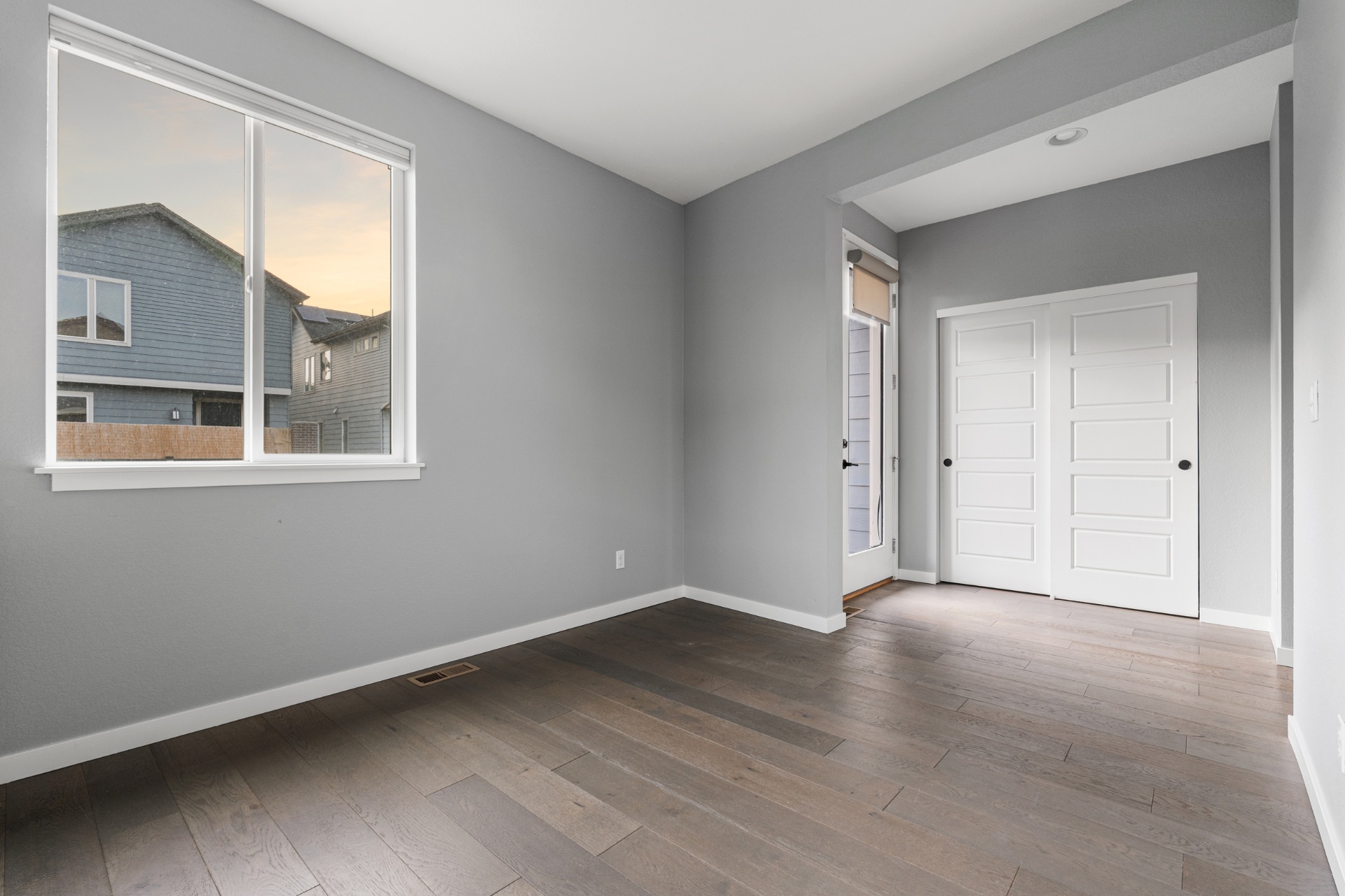 Main-level den with hardwood floors and access to the deck