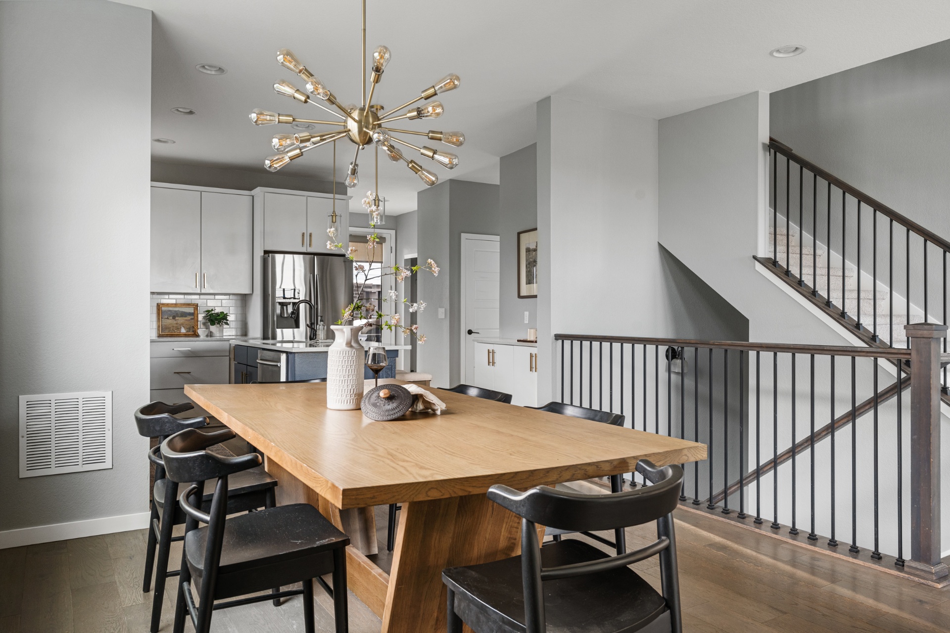 Open dining area with sputnik chandelier