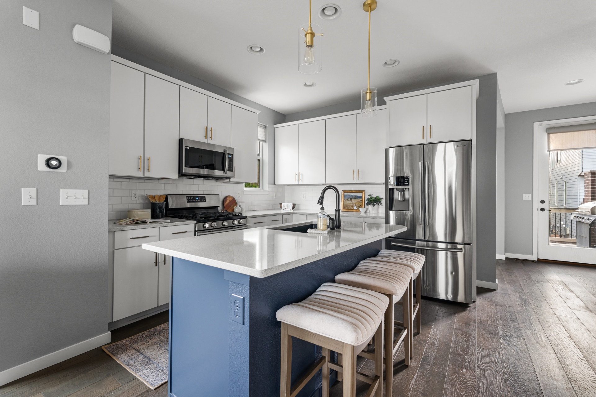 Kitchen with quartz countertops and navy island